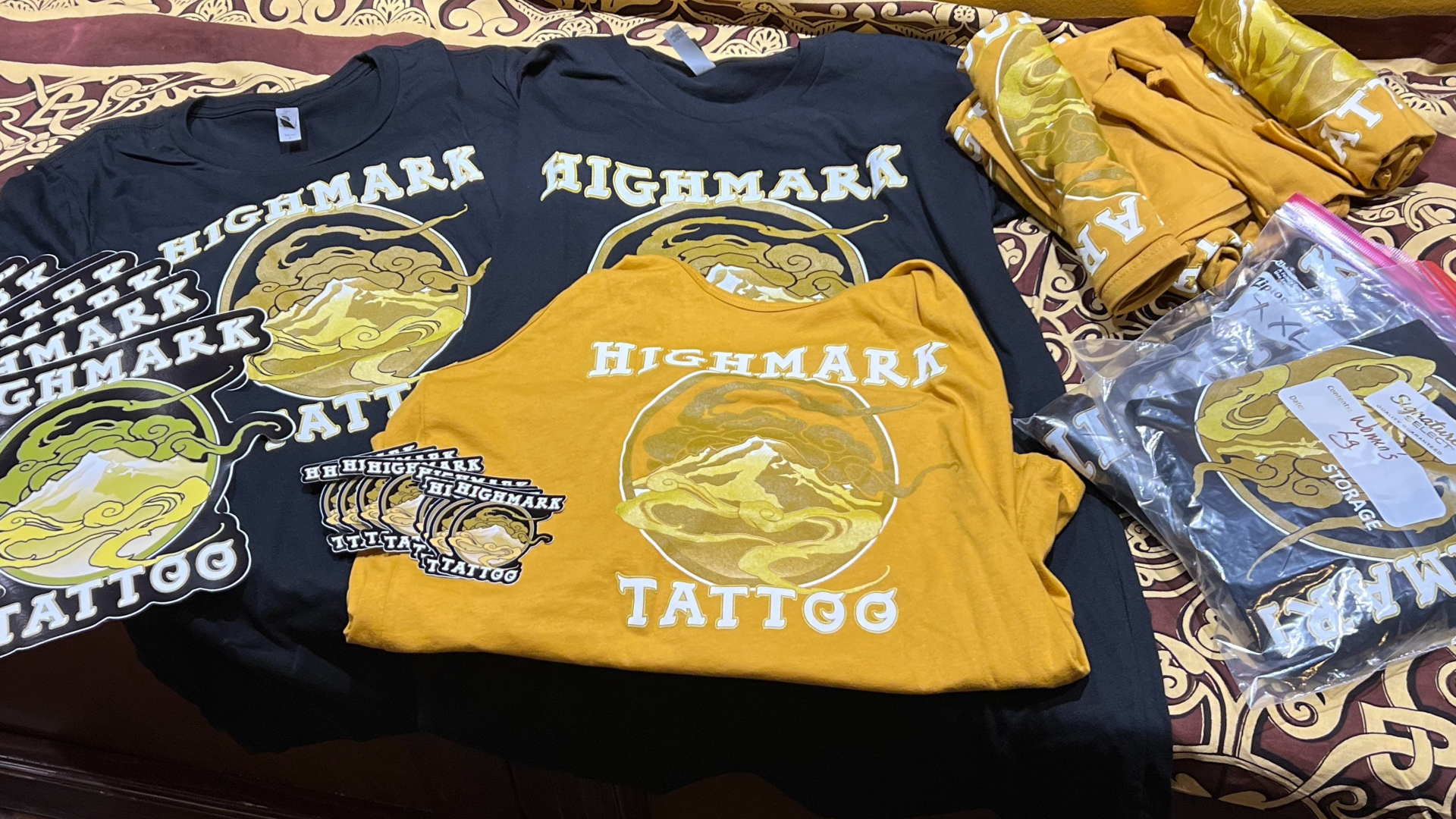 Highmark tattoo studio t-shirts An assortment of t-shirts and stickers bearing the logo of Highmark Tattoo Studio in Lynnwood, WA