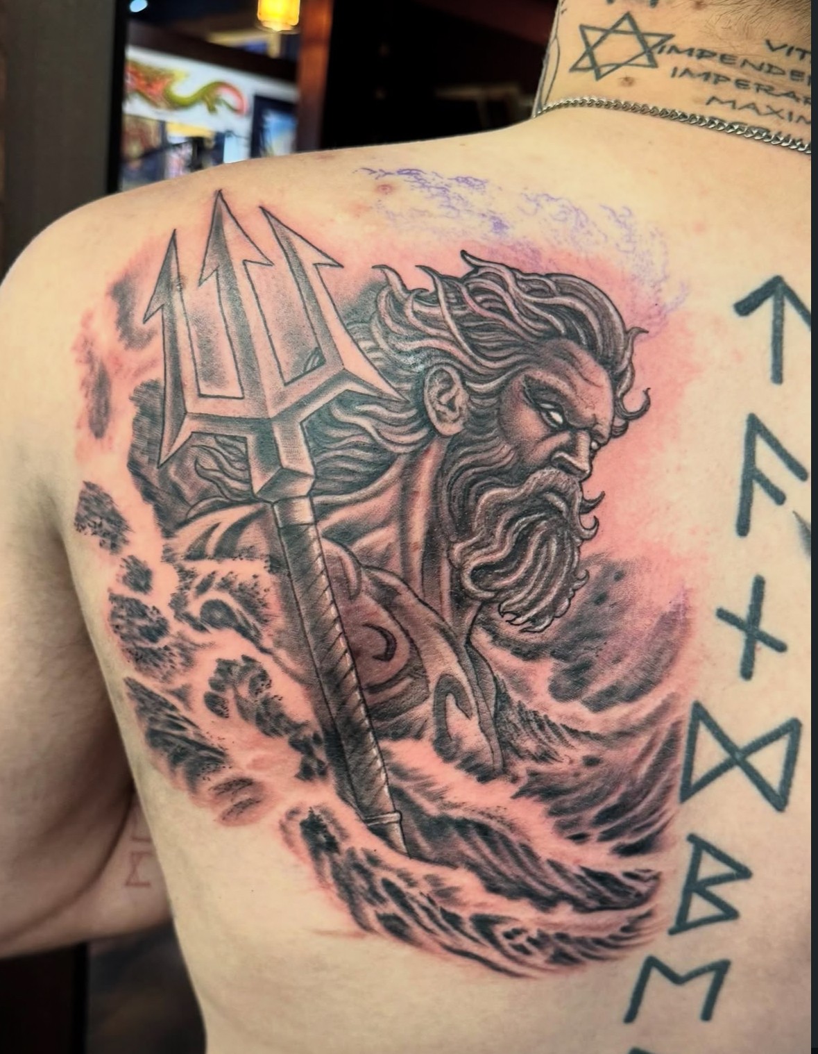 Blue whale with grey surf background tattoo by John Fitzgerald of Highmark Tattoo Studio in Lynnwood, WA.