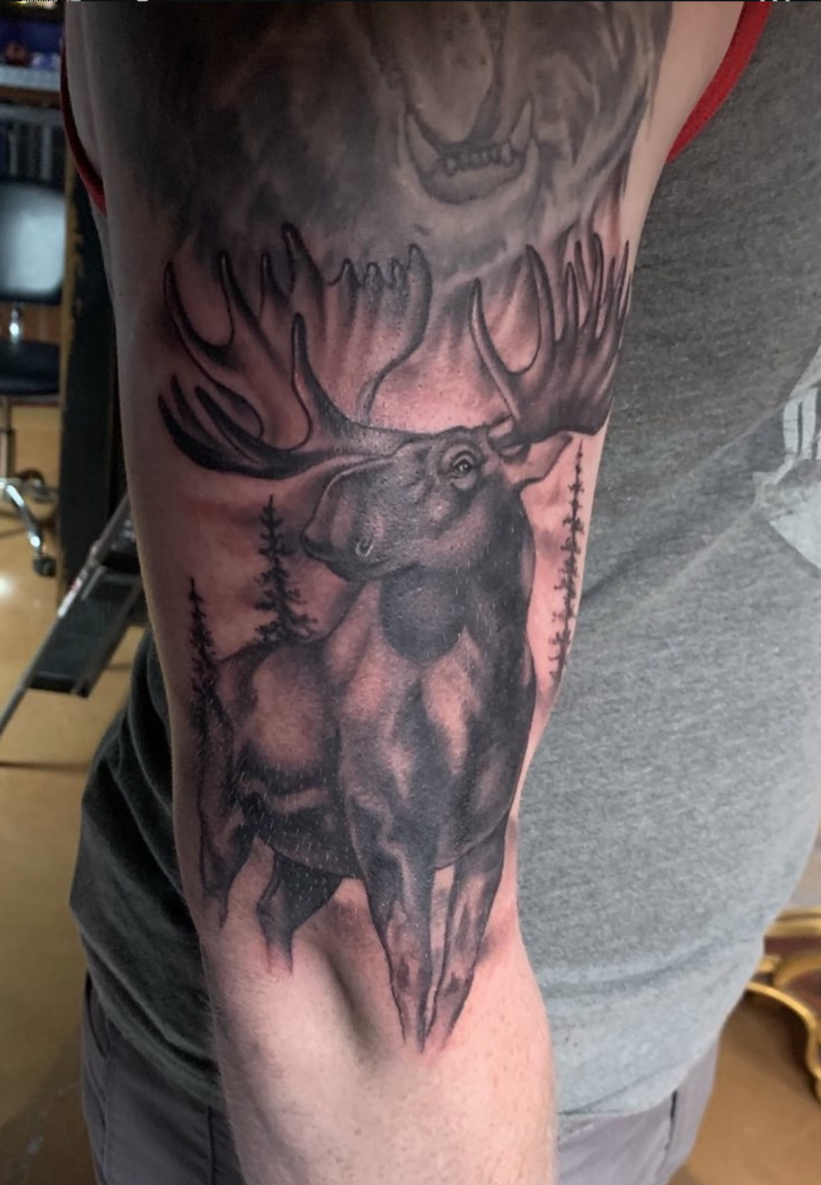 Blue whale with grey surf background tattoo by John Fitzgerald of Highmark Tattoo Studio in Lynnwood, WA.